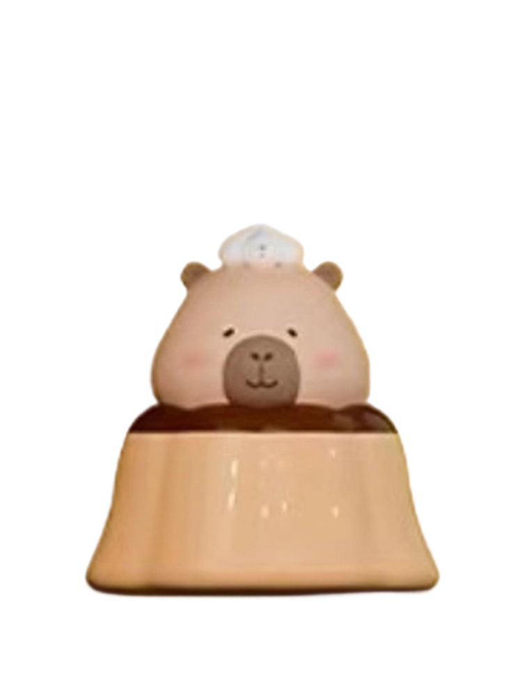 Caramel capybara mini figure sitting in a caramel pudding with a chef hat, from the Tuntunzai Bakery series
