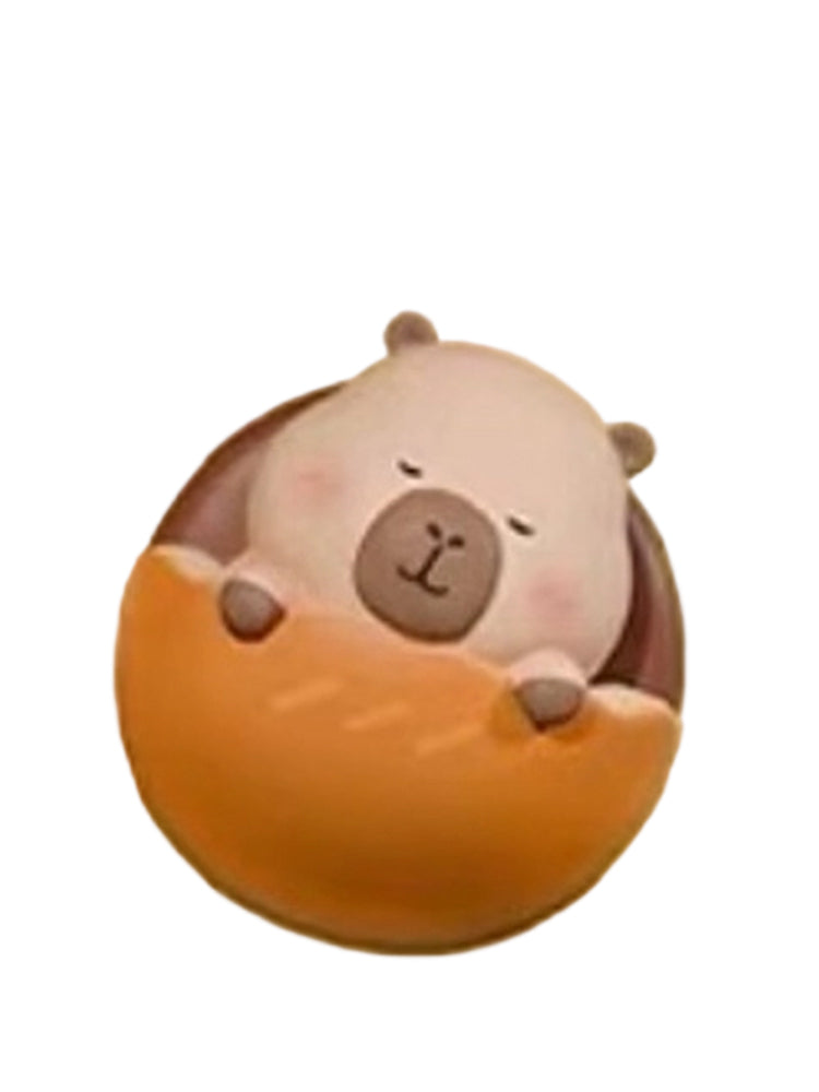 Dorayaki capybara mini figure tucked into a round dorayaki pancake, from the Tuntunzai Bakery series