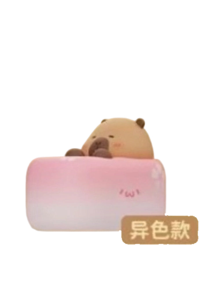 Sakura Cake Special capybara mini figure hugging a pink sakura cake roll, from the Tuntunzai Bakery V2 series