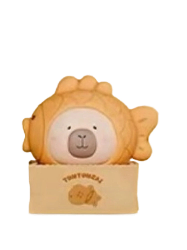 Taiyaki capybara mini figure wearing a taiyaki fish cake hood in a paper box, from the Tuntunzai Bakery series