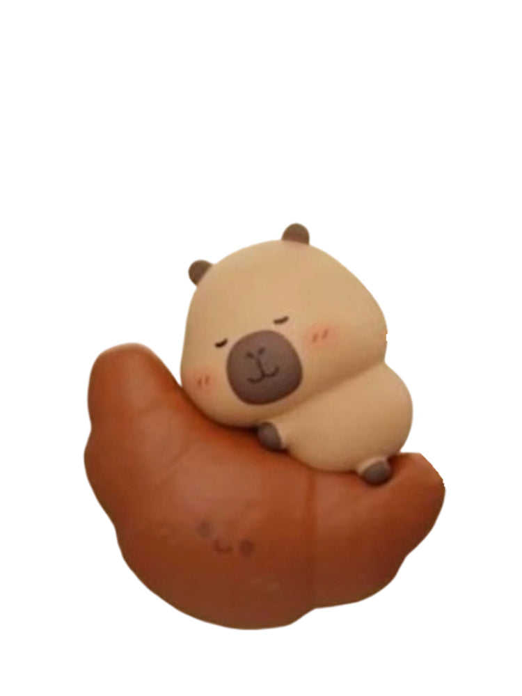 Tuntun Bread Secret capybara mini figure sleeping on a chocolate croissant, from the Tuntunzai Bakery V2 series