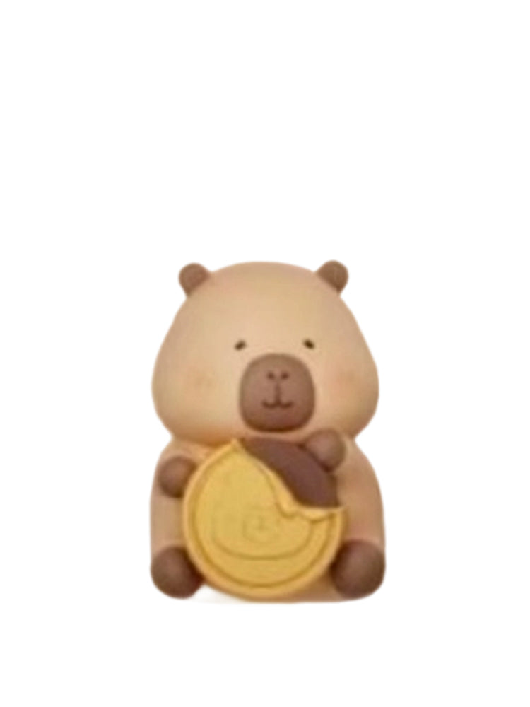 Tuntun Bursts Coins capybara mini figure holding a gold chocolate coin, from the Tuntunzai Capybara Chocolate series