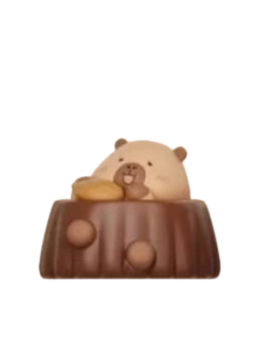 Almond Chocolate capybara mini figure peeking out of a round chocolate treat topped with almonds, from the Tuntunzai Capybara Chocolate series