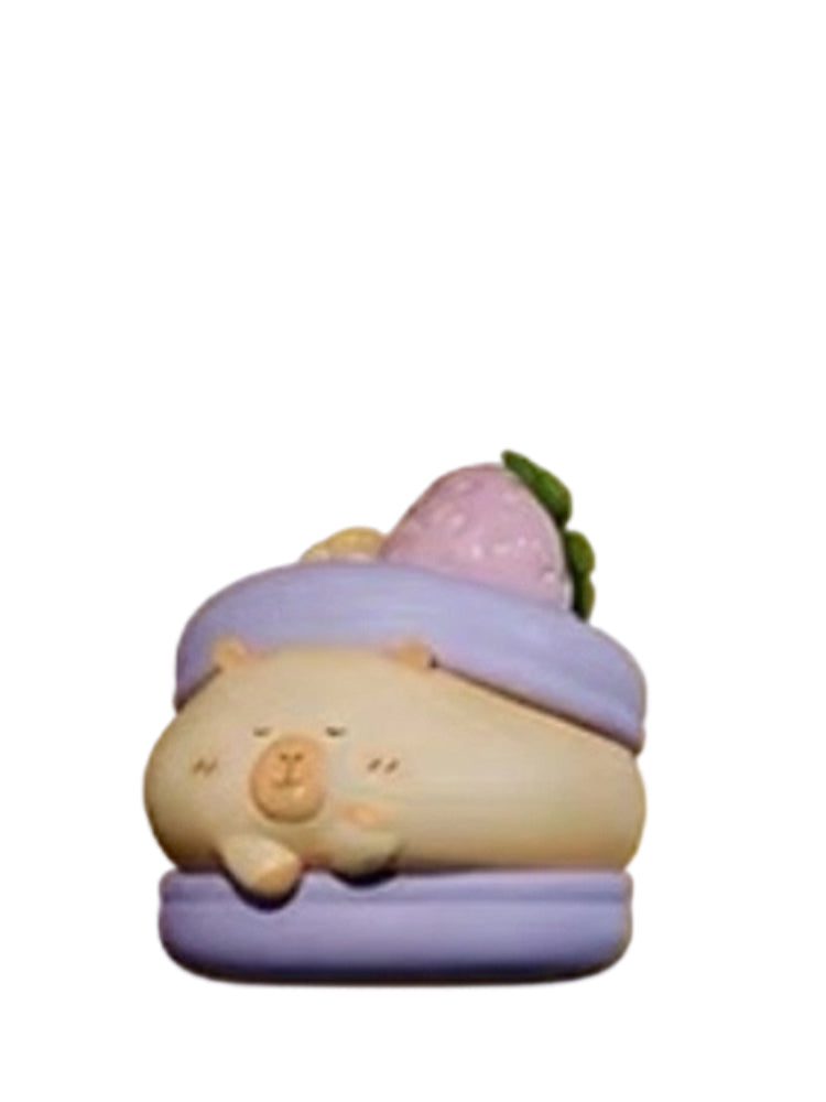 Blueberry Macaron Special capybara mini figure lying on a purple blueberry macaron with a strawberry, from the Tuntunzai Bakery series