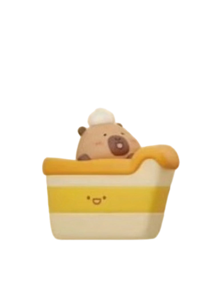 Cake capybara mini figure sitting in a layered cake slice with cream on top, from the Tuntunzai Bakery V2 series
