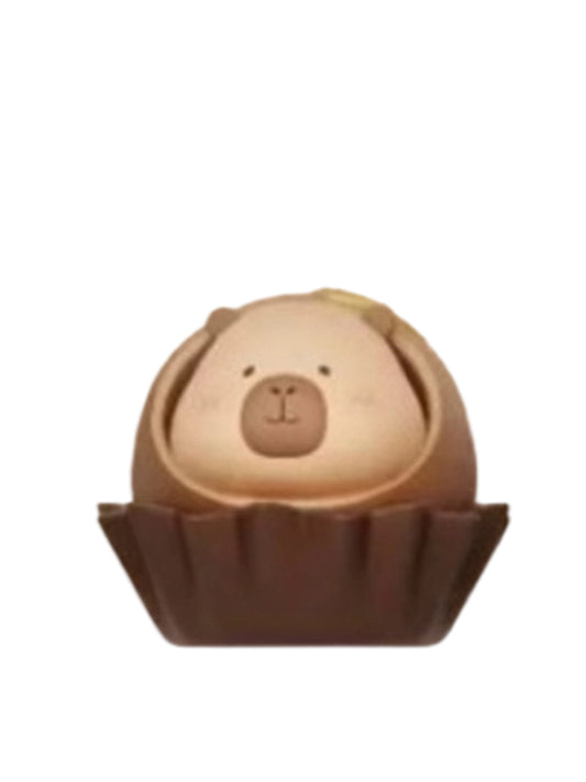 Chocolate Liqueur capybara mini figure nestled in a round chocolate truffle in a paper cup, from the Tuntunzai Capybara Chocolate series