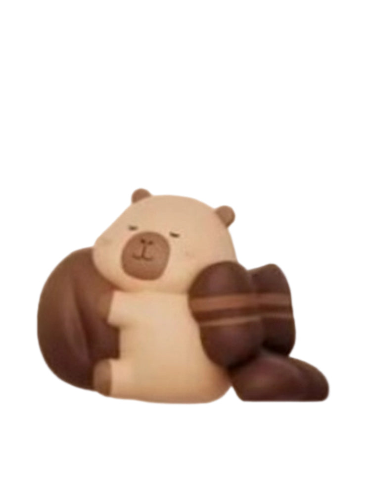 Coffee Chocolate capybara mini figure hugging a coffee bean shaped chocolate, from the Tuntunzai Capybara Chocolate series