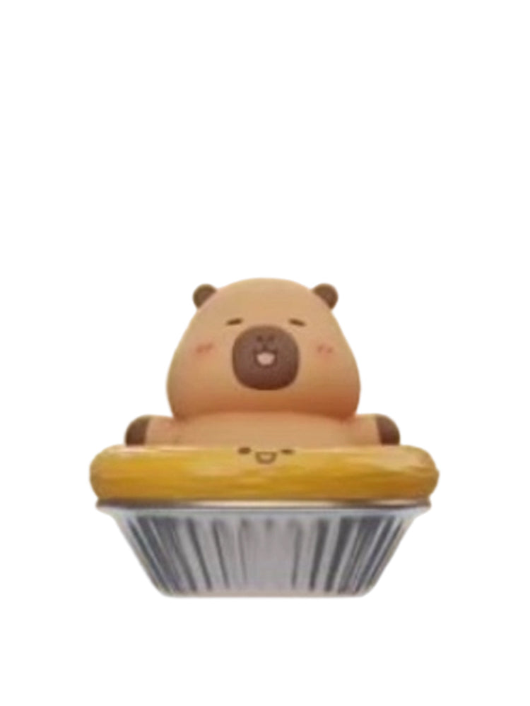 Egg Tarts capybara mini figure sitting in an egg tart in a foil cup, from the Tuntunzai Bakery V2 series