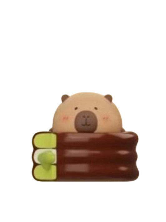 Flowing Pie capybara mini figure hugging a layered chocolate and matcha pie, from the Tuntunzai Bakery V2 series