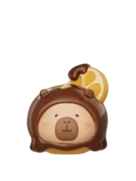 Grapefruit Chocolate capybara mini figure in a chocolate-dipped treat topped with a grapefruit slice, from the Tuntunzai Capybara Chocolate series