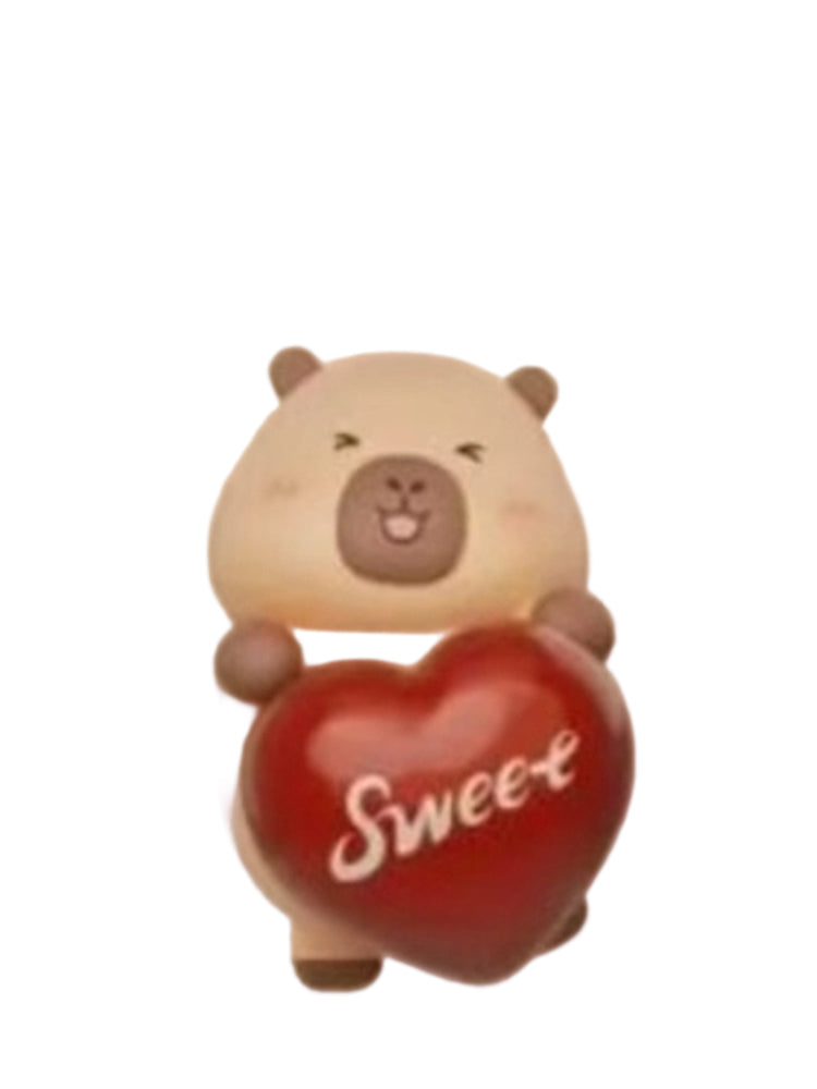 Heart-shaped Choco capybara mini figure holding a red heart-shaped chocolate that reads Sweet, from the Tuntunzai Capybara Chocolate series