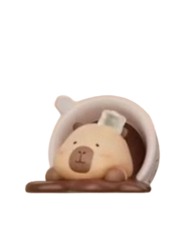 Hot Overflow Cocoa capybara mini figure lounging in a tipped-over cup of spilled cocoa, from the Tuntunzai Capybara Chocolate series