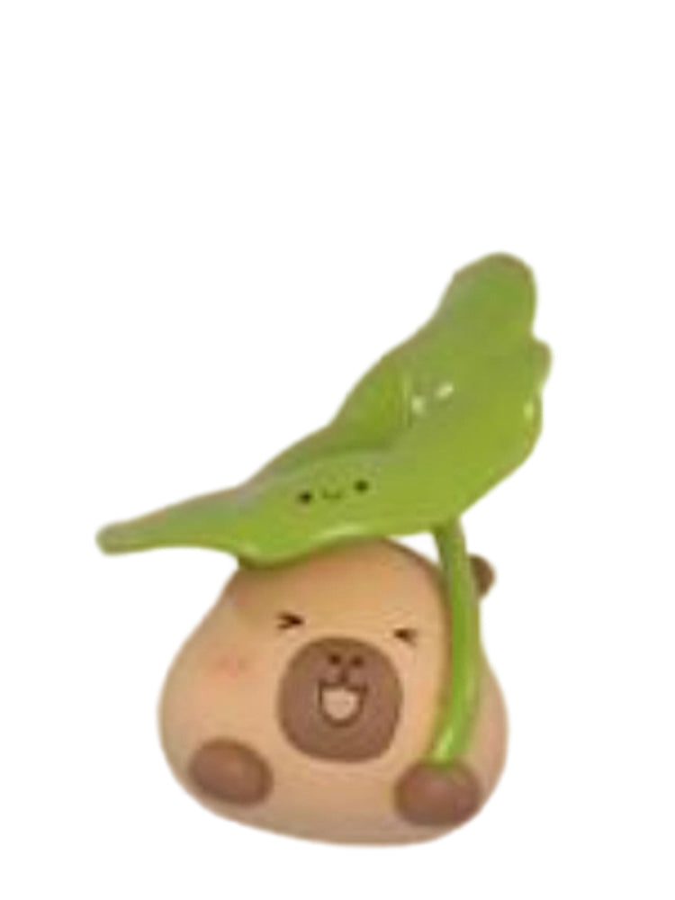 Lotus Leaf capybara mini figure holding a lotus leaf like an umbrella, from the Tuntunzai Wellness series