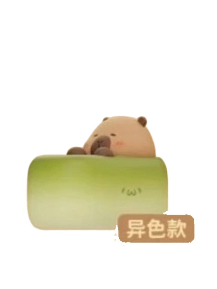 Matcha Cake Special capybara mini figure hugging a green matcha cake roll, from the Tuntunzai Bakery V2 series