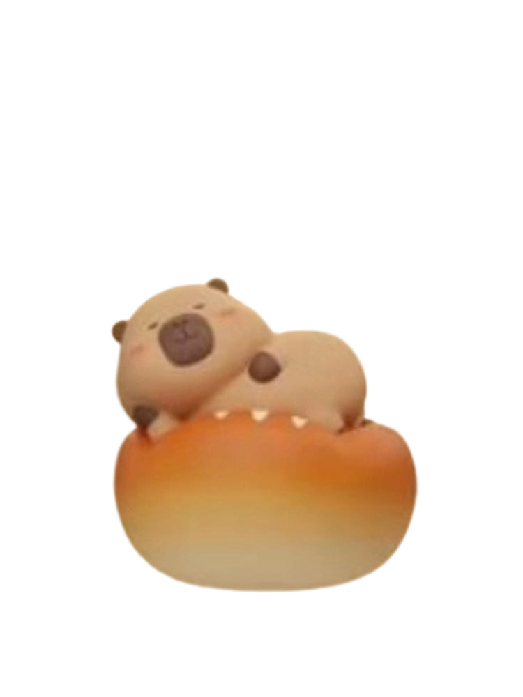 Ououbao capybara mini figure lying on top of a round bread bun, from the Tuntunzai Bakery V2 series