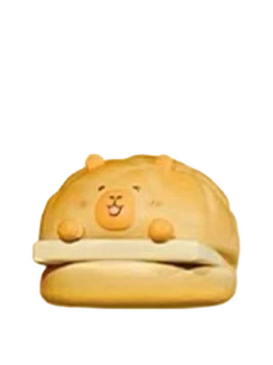 Pineapple Bun capybara mini figure tucked inside a golden pineapple bun, from the Tuntunzai Bakery series
