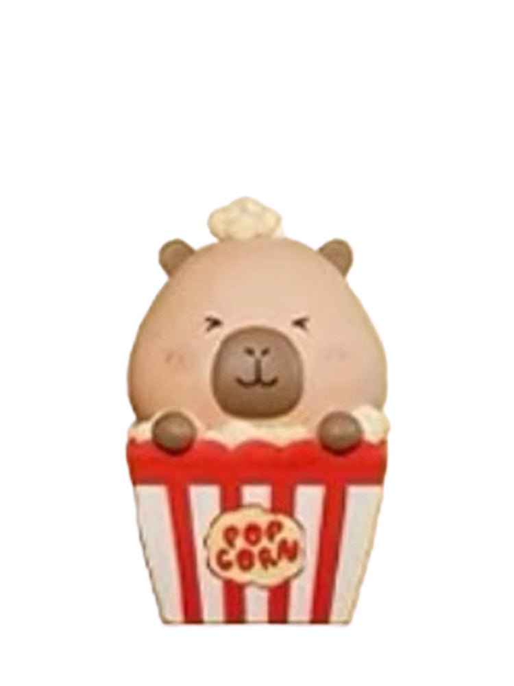 Popcorn capybara mini figure popping out of a red striped popcorn box, from the Tuntunzai Bakery series