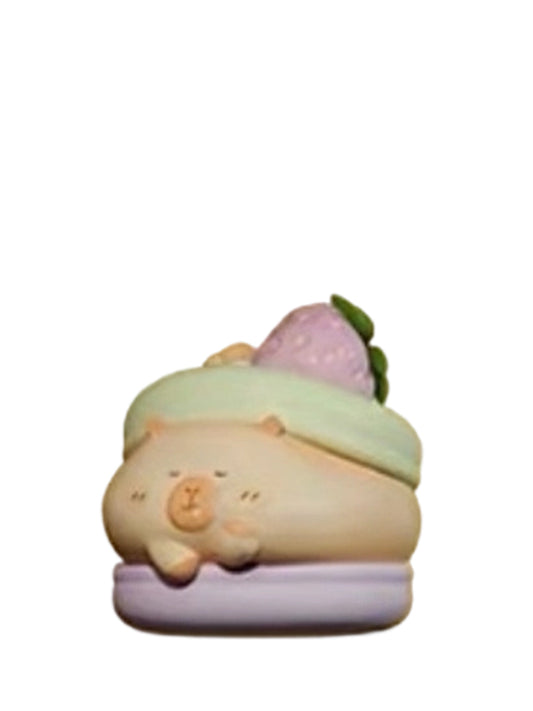 Two Tone Macaron Special capybara mini figure lying on a green and purple macaron with a strawberry, from the Tuntunzai Bakery series