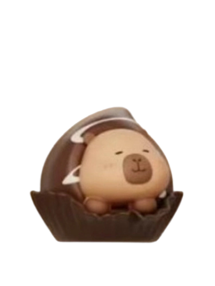 Velvet Dark Choco capybara mini figure inside a dark chocolate truffle in a paper cup, from the Tuntunzai Capybara Chocolate series